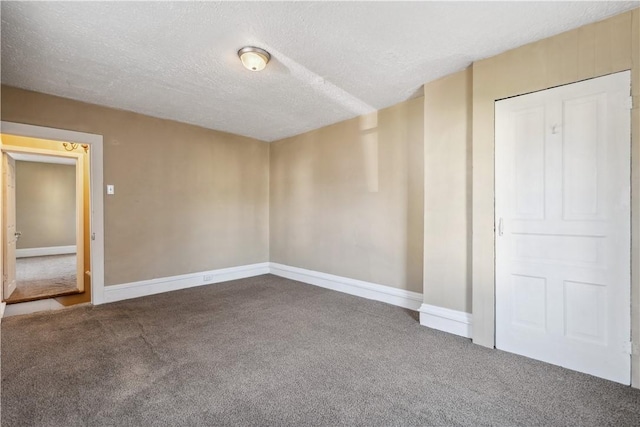 unfurnished bedroom featuring a textured ceiling, baseboards, and carpet flooring