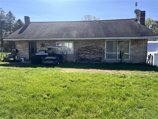 rear view of house featuring a lawn