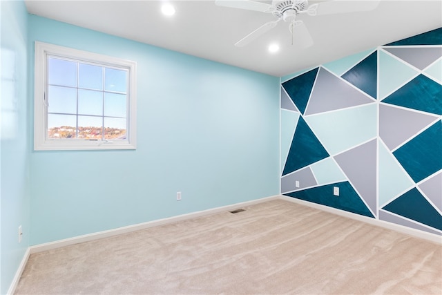 spare room with carpet floors and ceiling fan