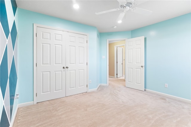 unfurnished bedroom with a closet, ceiling fan, and light carpet