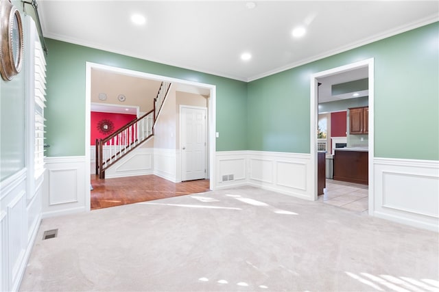 carpeted empty room with crown molding