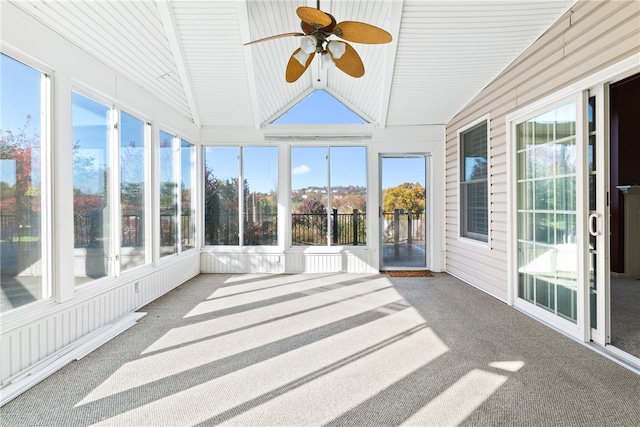 unfurnished sunroom featuring ceiling fan, lofted ceiling, and plenty of natural light