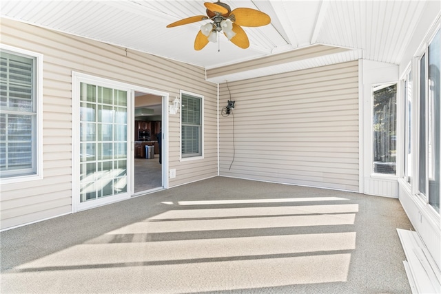 unfurnished sunroom with ceiling fan and a healthy amount of sunlight