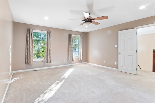 carpeted spare room with ceiling fan