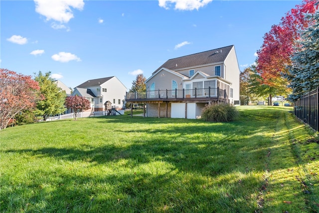 rear view of property with a deck and a lawn