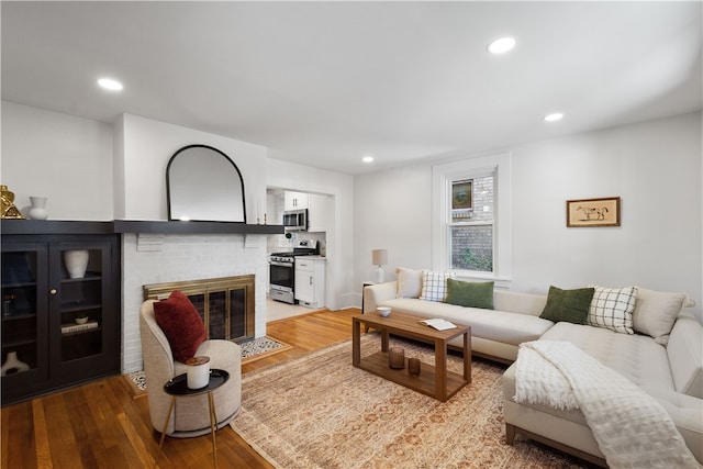 living room featuring a fireplace and hardwood / wood-style flooring