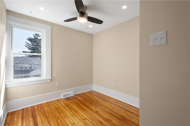 empty room with hardwood / wood-style flooring and ceiling fan