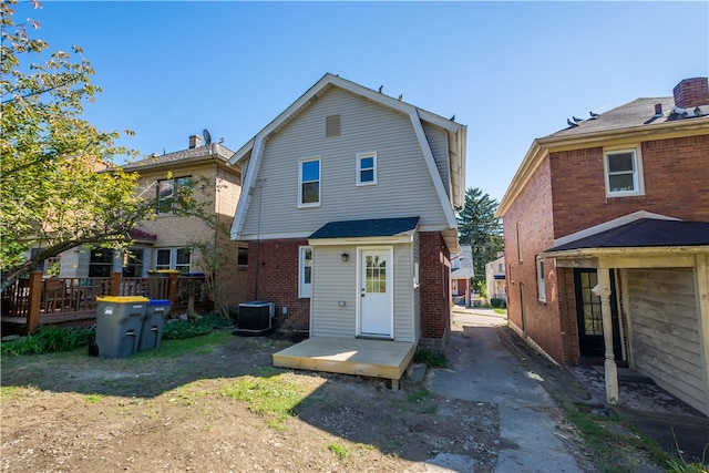 back of house with a wooden deck and central air condition unit