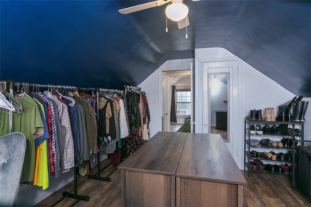 walk in closet with dark hardwood / wood-style floors, ceiling fan, and vaulted ceiling