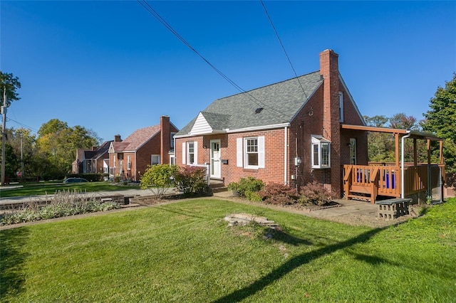 rear view of house with a wooden deck and a lawn