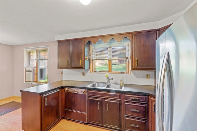 kitchen featuring kitchen peninsula, stainless steel refrigerator, dishwasher, and a wealth of natural light