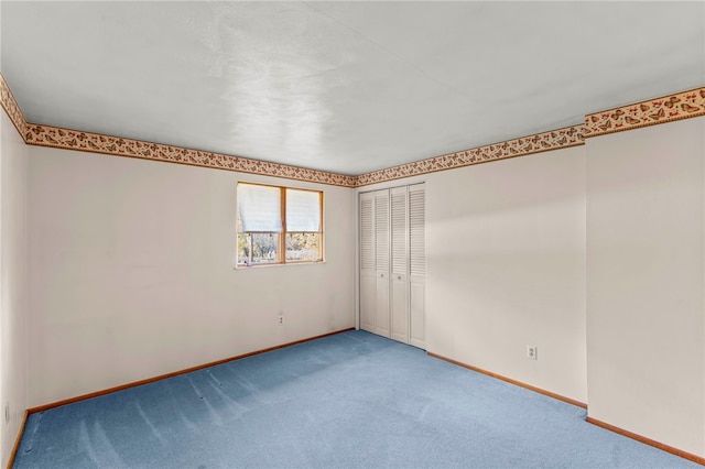 unfurnished room featuring carpet