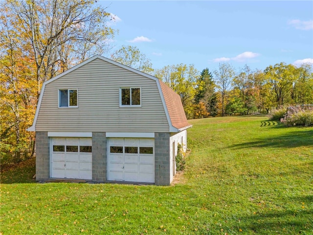 view of side of home featuring a garage and a lawn