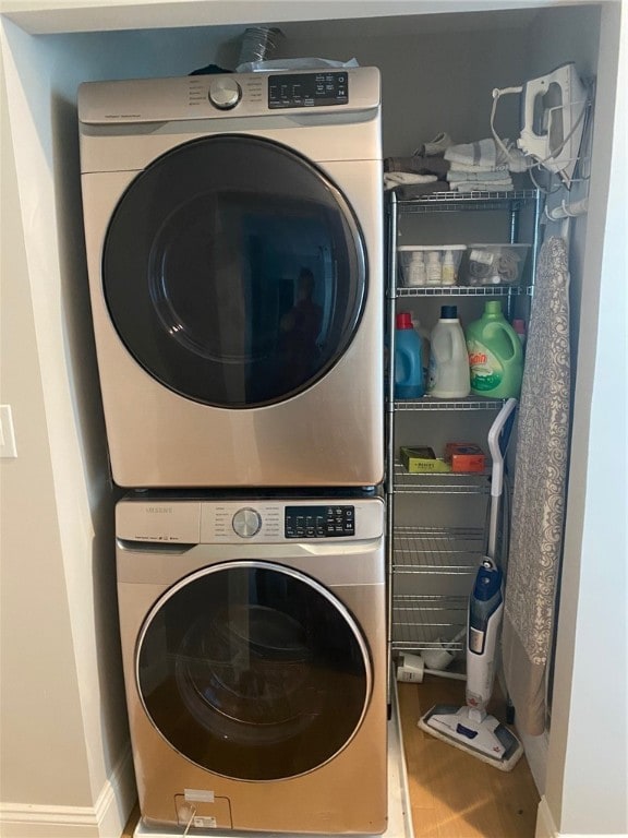 clothes washing area featuring stacked washer / drying machine