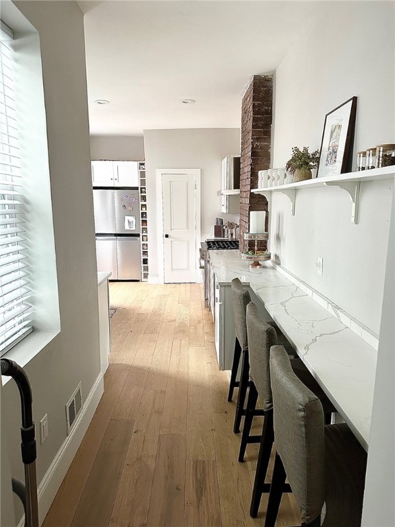 hallway with light wood-type flooring