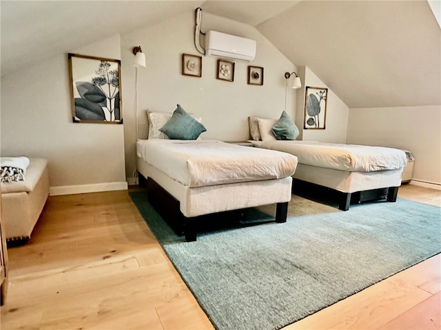 bedroom featuring a wall mounted AC, hardwood / wood-style flooring, and lofted ceiling