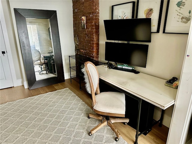 home office featuring hardwood / wood-style flooring and built in desk