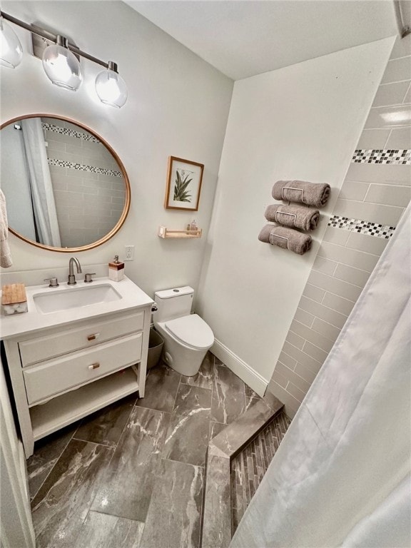 bathroom featuring vanity, toilet, and walk in shower