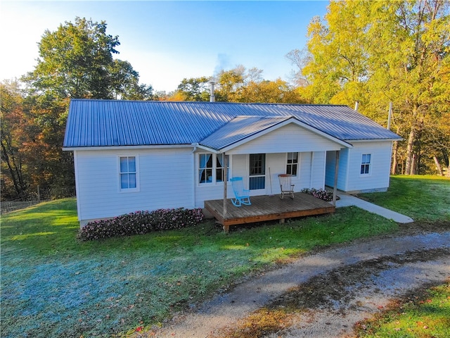 ranch-style house with a wooden deck and a front lawn