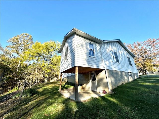 back of property with a patio area and a yard