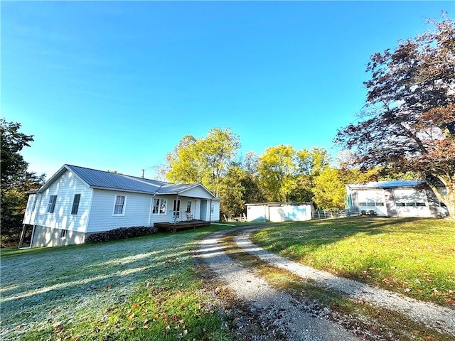 view of front of home with a wooden deck and a front lawn