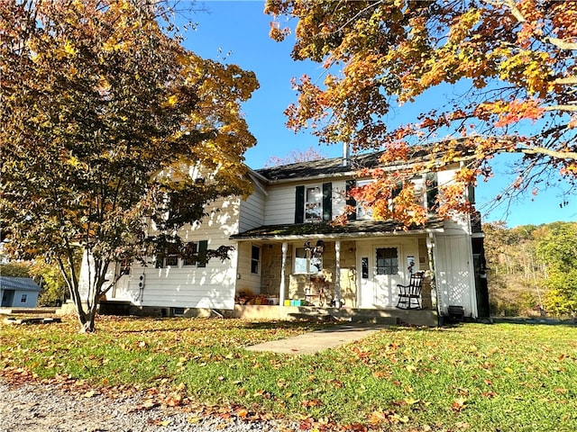 view of front of home featuring a front yard and covered porch