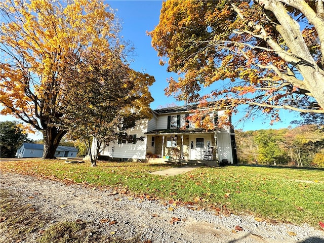 view of front of property with a porch and a front lawn