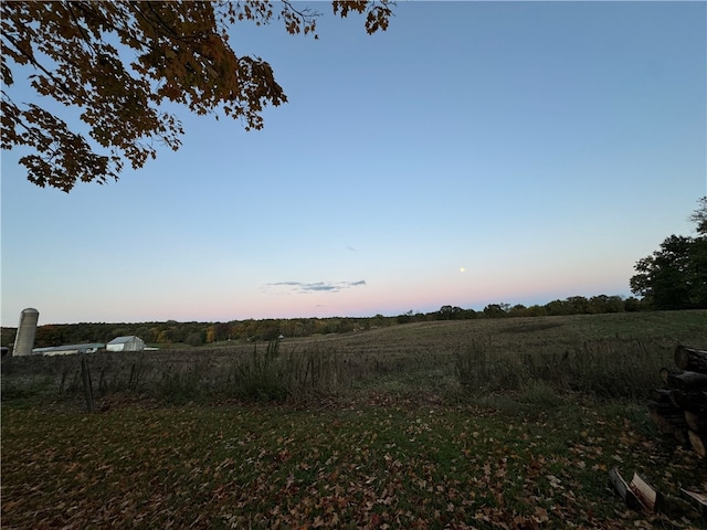 nature at dusk featuring a rural view