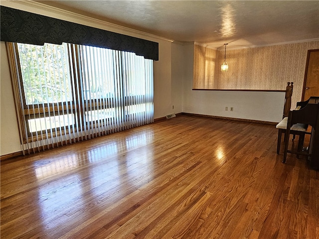 unfurnished living room with ornamental molding and dark hardwood / wood-style flooring