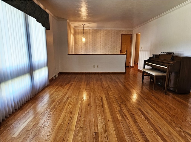 unfurnished living room with crown molding and wood-type flooring