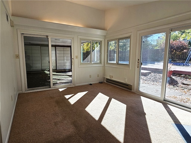 unfurnished sunroom with a baseboard heating unit