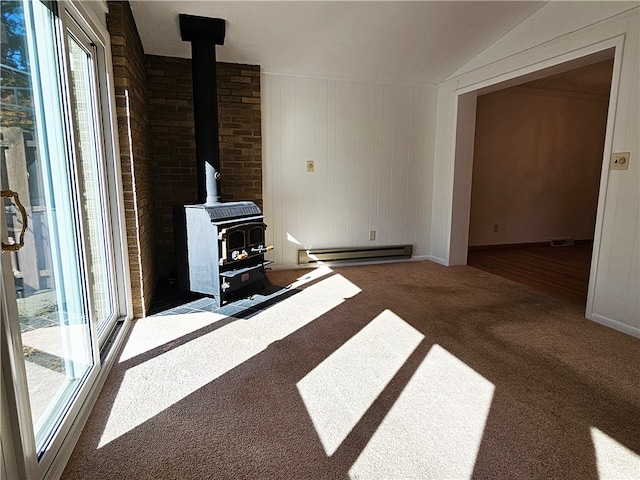 unfurnished living room featuring dark carpet, vaulted ceiling, a baseboard heating unit, and a wood stove