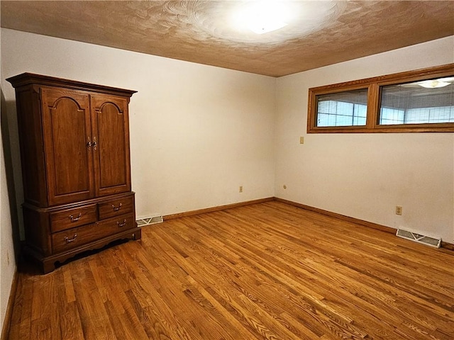 2656 Shelly Dr, White Twp Ind, PA 15701 - empty room with baseboards, wood finished floors, visible vents, and a textured ceiling