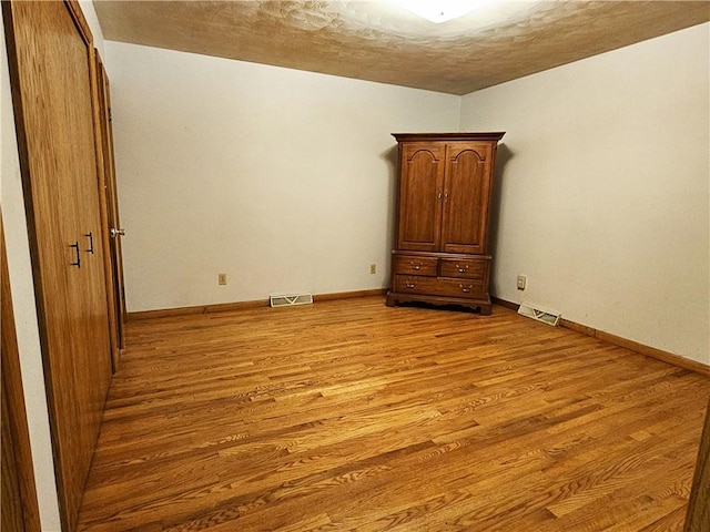 2656 Shelly Dr, White Twp Ind, PA 15701 - unfurnished bedroom with baseboards, visible vents, a textured ceiling, and light wood-style floors