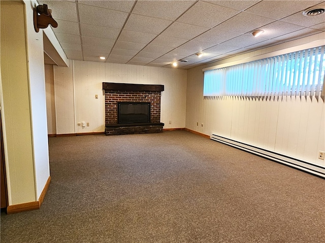 unfurnished living room featuring a paneled ceiling, carpet flooring, a baseboard radiator, and a fireplace