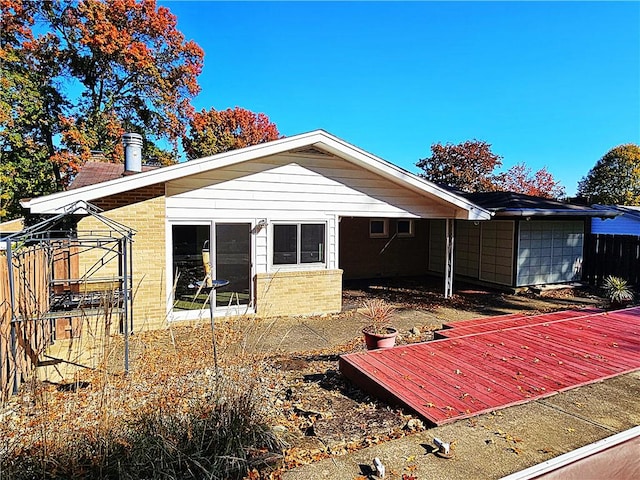 2656 Shelly Dr, White Twp Ind, PA 15701 - rear view of house featuring brick siding, a garage, and fence