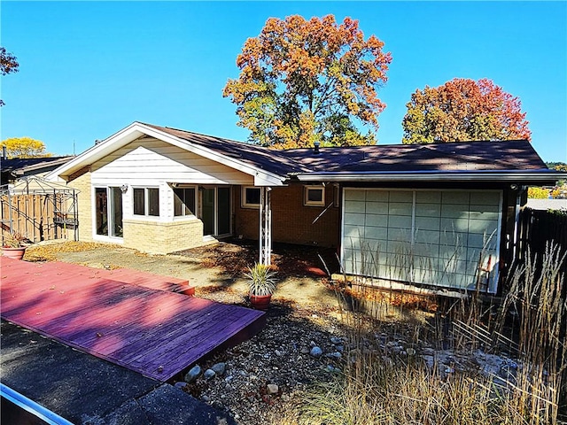 2656 Shelly Dr, White Twp Ind, PA 15701 - back of property with an attached garage, fence, brick siding, and a deck