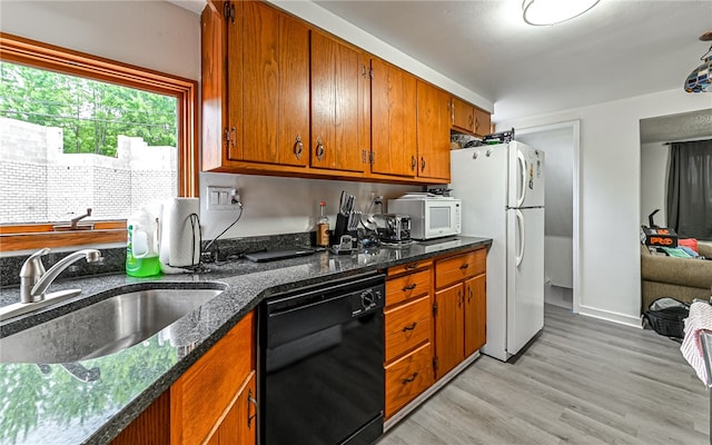 kitchen with white appliances, sink, and light hardwood / wood-style flooring