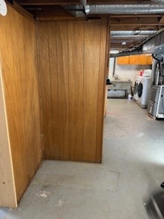 basement featuring washer / clothes dryer and wooden walls