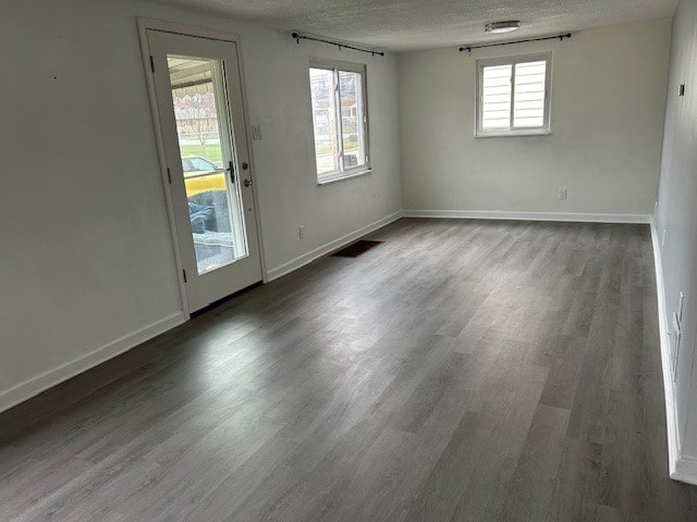 spare room with wood-type flooring and a textured ceiling