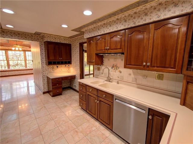 kitchen with sink, ceiling fan, stainless steel dishwasher, ornamental molding, and light tile patterned floors