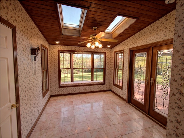 unfurnished sunroom featuring french doors, ceiling fan, wooden ceiling, and lofted ceiling with skylight