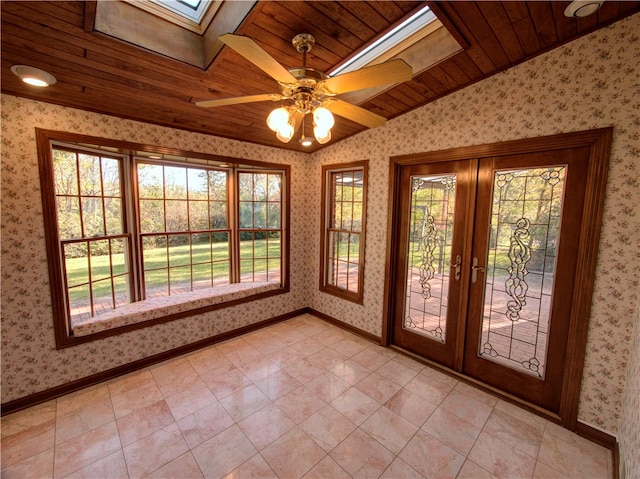 unfurnished sunroom with lofted ceiling with skylight, french doors, wood ceiling, and ceiling fan