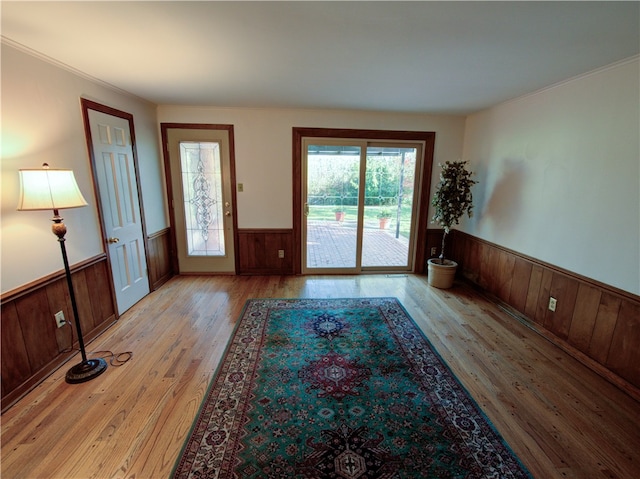 entryway featuring crown molding and light hardwood / wood-style flooring