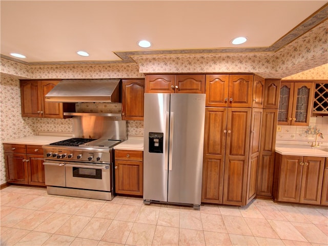 kitchen featuring tasteful backsplash, appliances with stainless steel finishes, light tile patterned flooring, and premium range hood