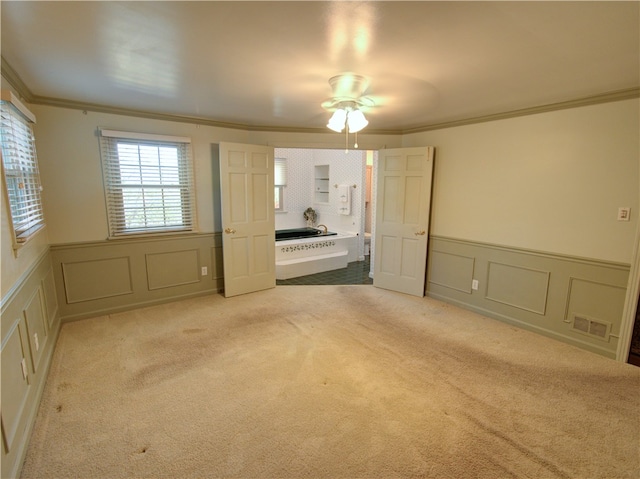 carpeted spare room with ornamental molding and ceiling fan