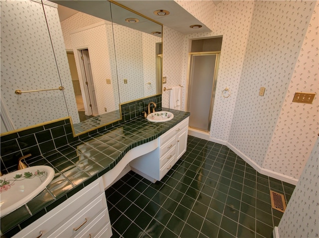 bathroom with vanity, walk in shower, and tile patterned floors