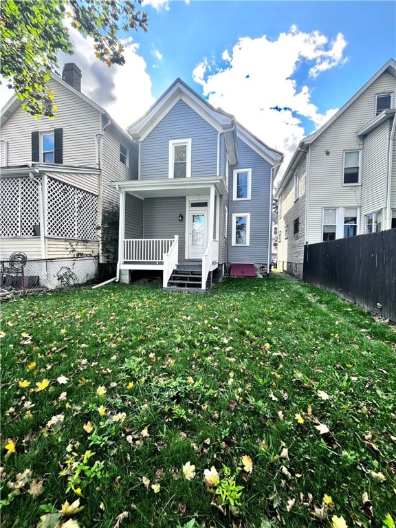 back of property featuring a lawn