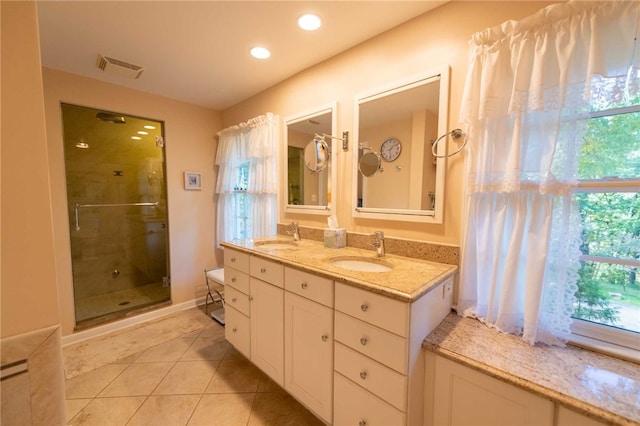 bathroom featuring vanity, tile patterned floors, and an enclosed shower