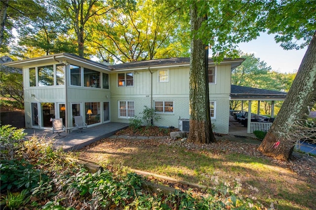 back of property with a patio and cooling unit